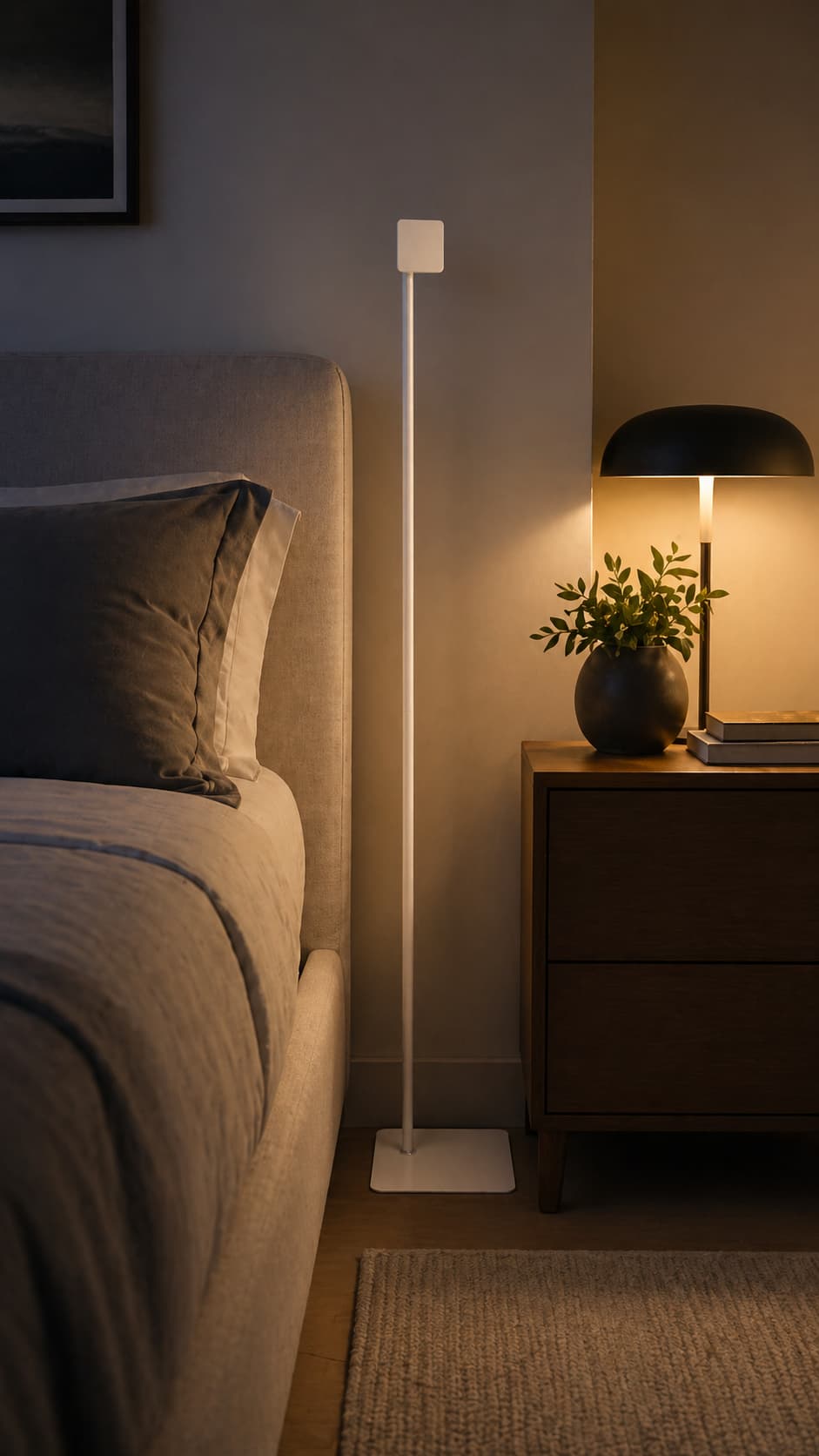 A quiet bedroom at night — bedside lamp glowing, plant on the nightstand